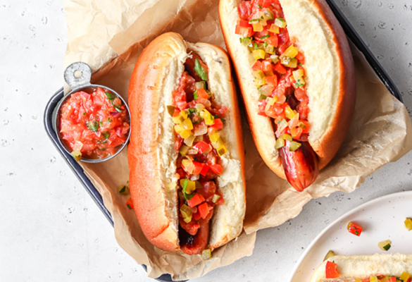 Homemade tomato relish on hot dogs