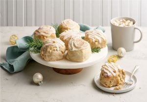 A variety of scones on a plate next to a warm cup of coffee, hot chocolate, or tea. Eggnog Scones, Gingerbread Scones